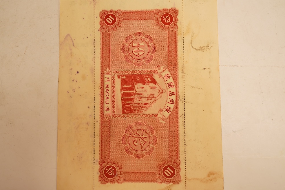 Macau Chan Tung Cheng Bank 1934 10 Yuan banknote, unissued remainder, with original perforated counterfoils. Issued for trade purposes during the Portuguese occupation of Macau. Typical staple holes and light ink blottin